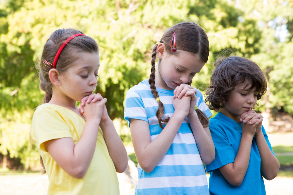 Schülerinnen und Schüler der Christlichen Schule beim gemeinsamen Beten. (Bild: wavebreakmedien - shutterstock.com)
